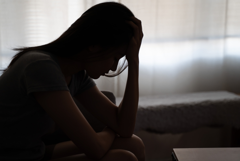 silhouette of a woman with her head in her hand